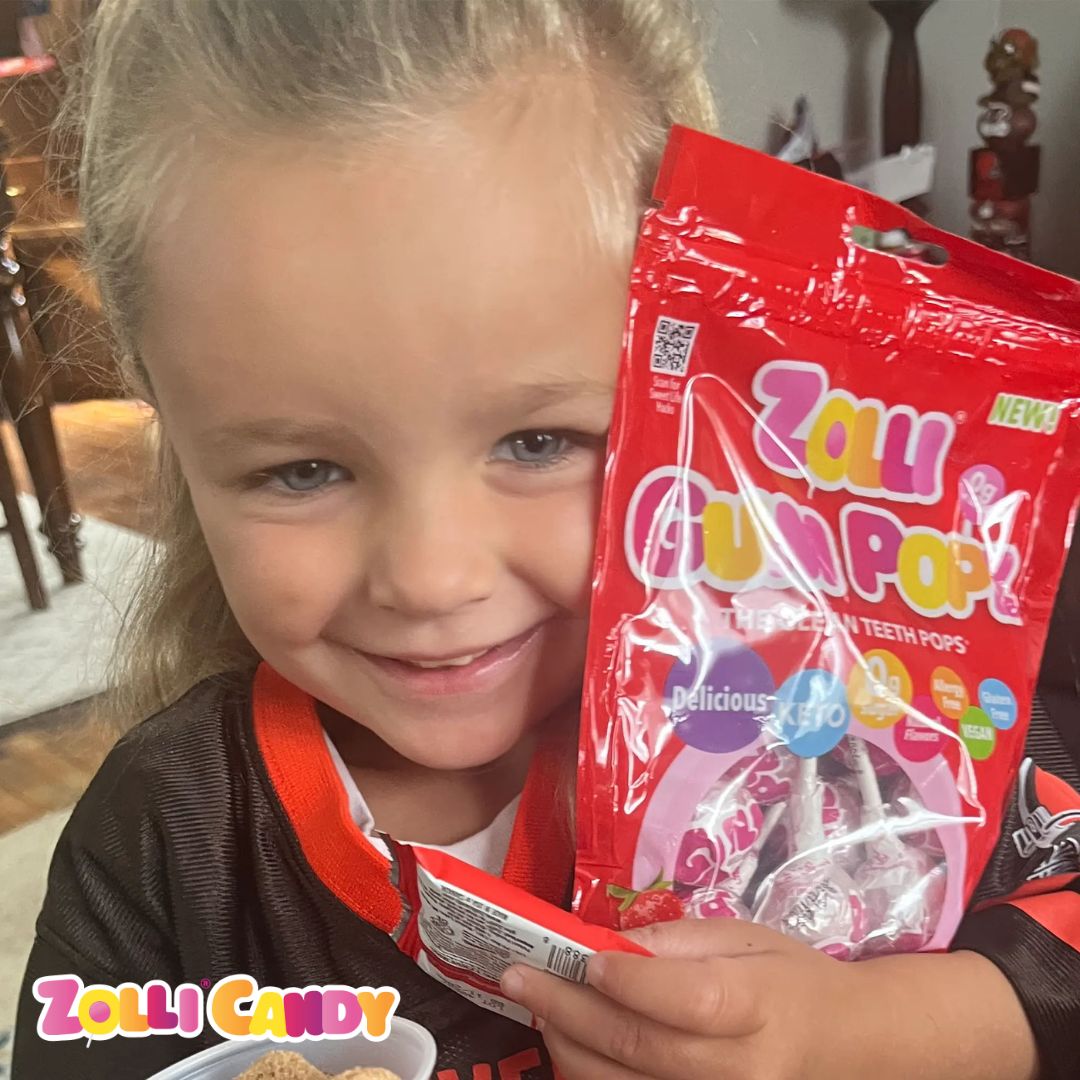 Girl holding bag of gum lollipops
