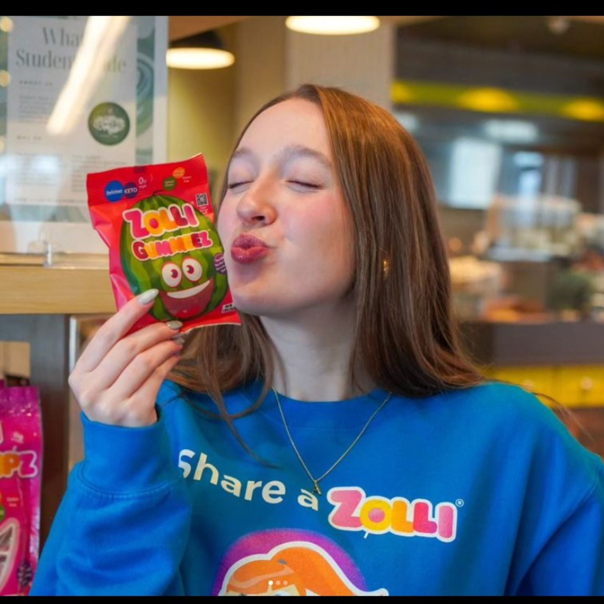 Young woman holding watermelon gummeez.