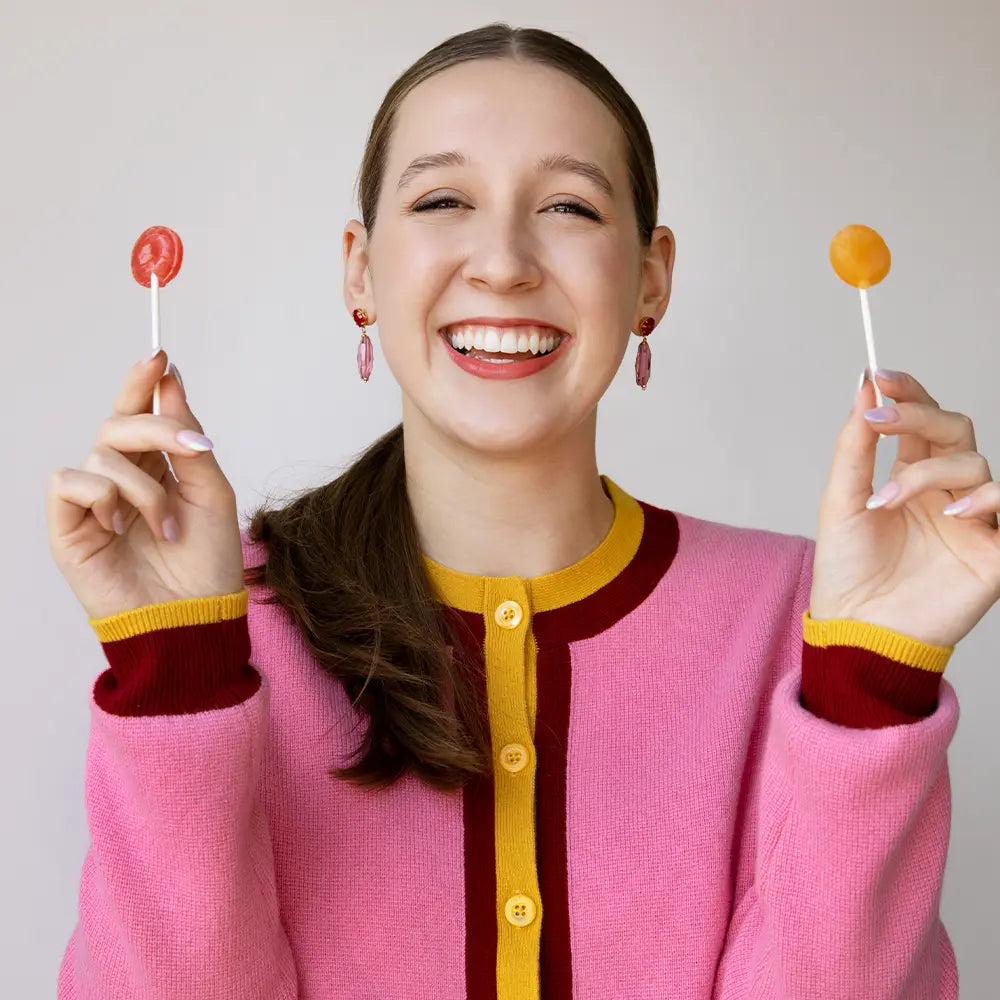 Alina Morse holding lollipops.