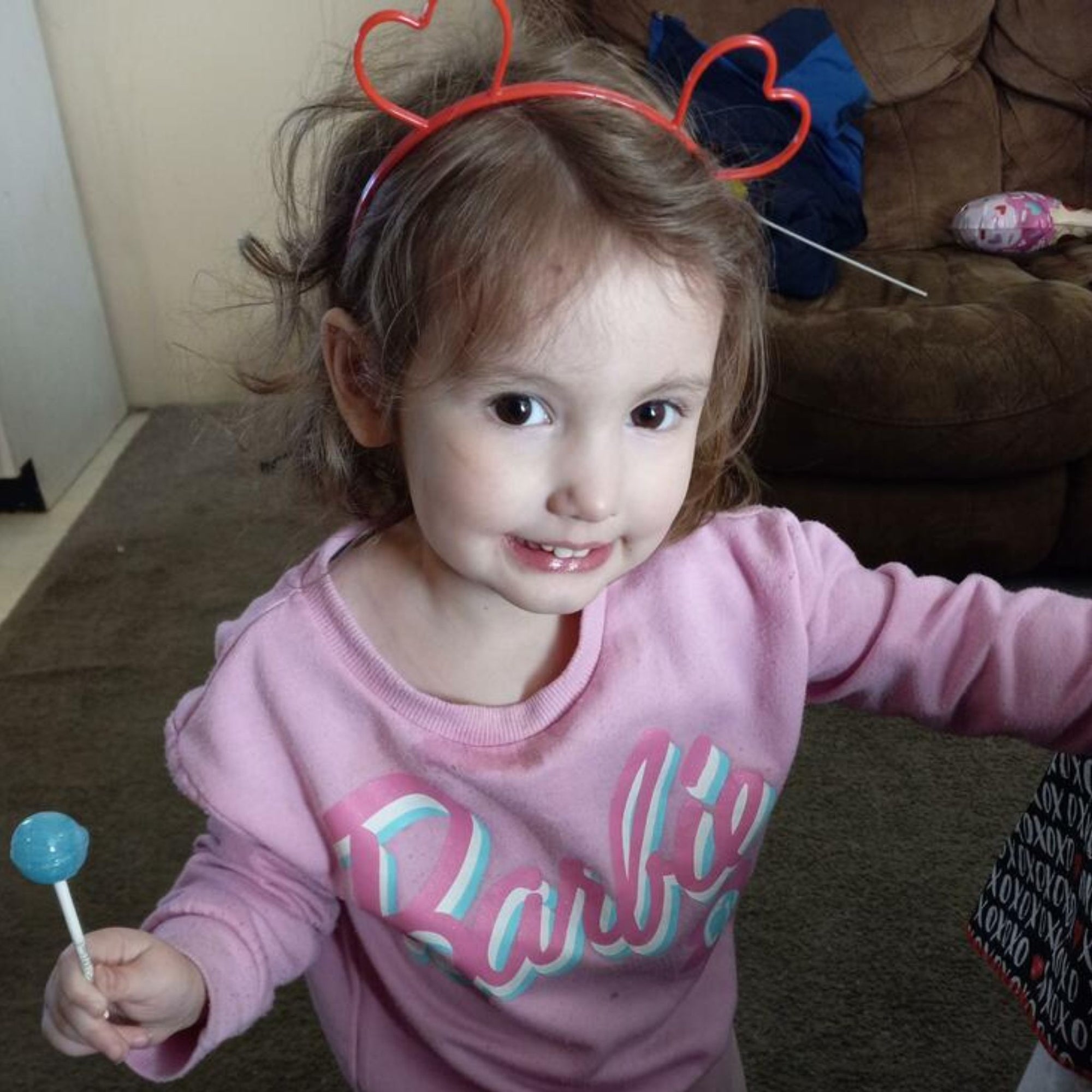 Child with a blue raspberry ball pop.