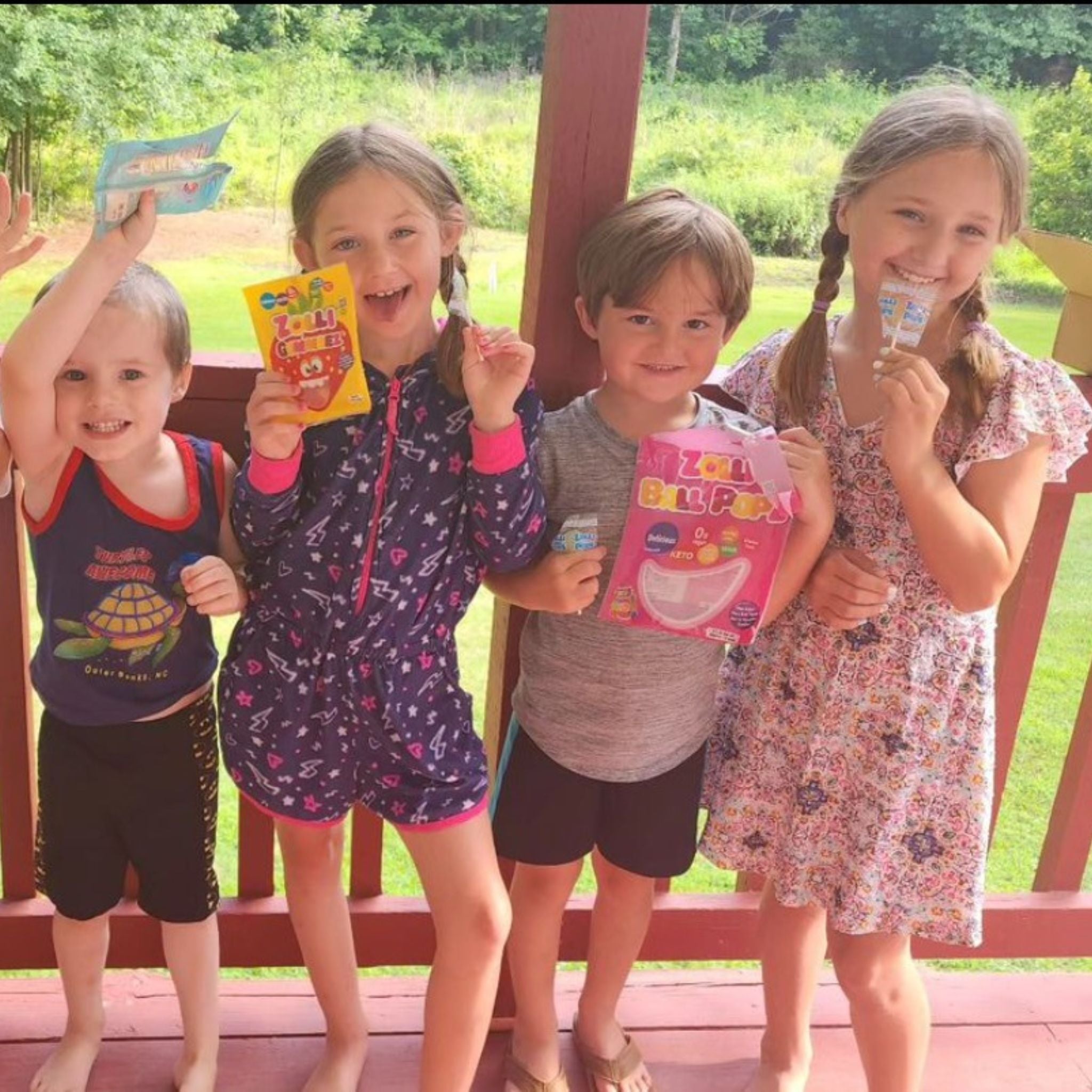 Four children holding bags of zolli candy.