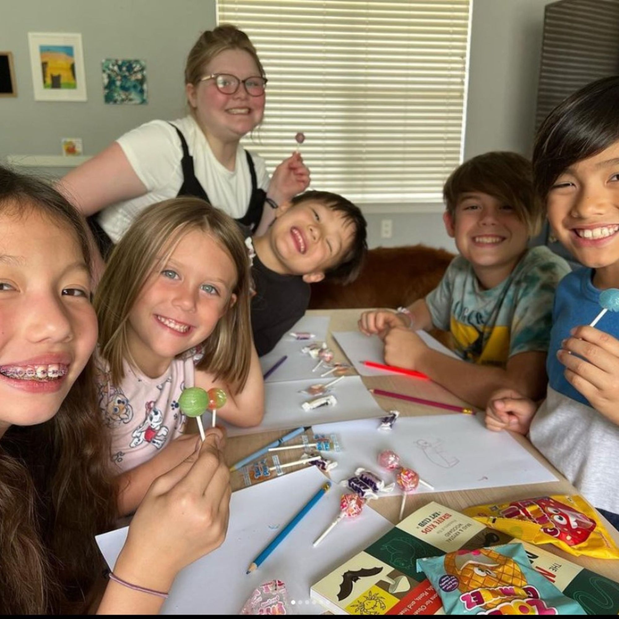 Kids at a table eating zolli candy.