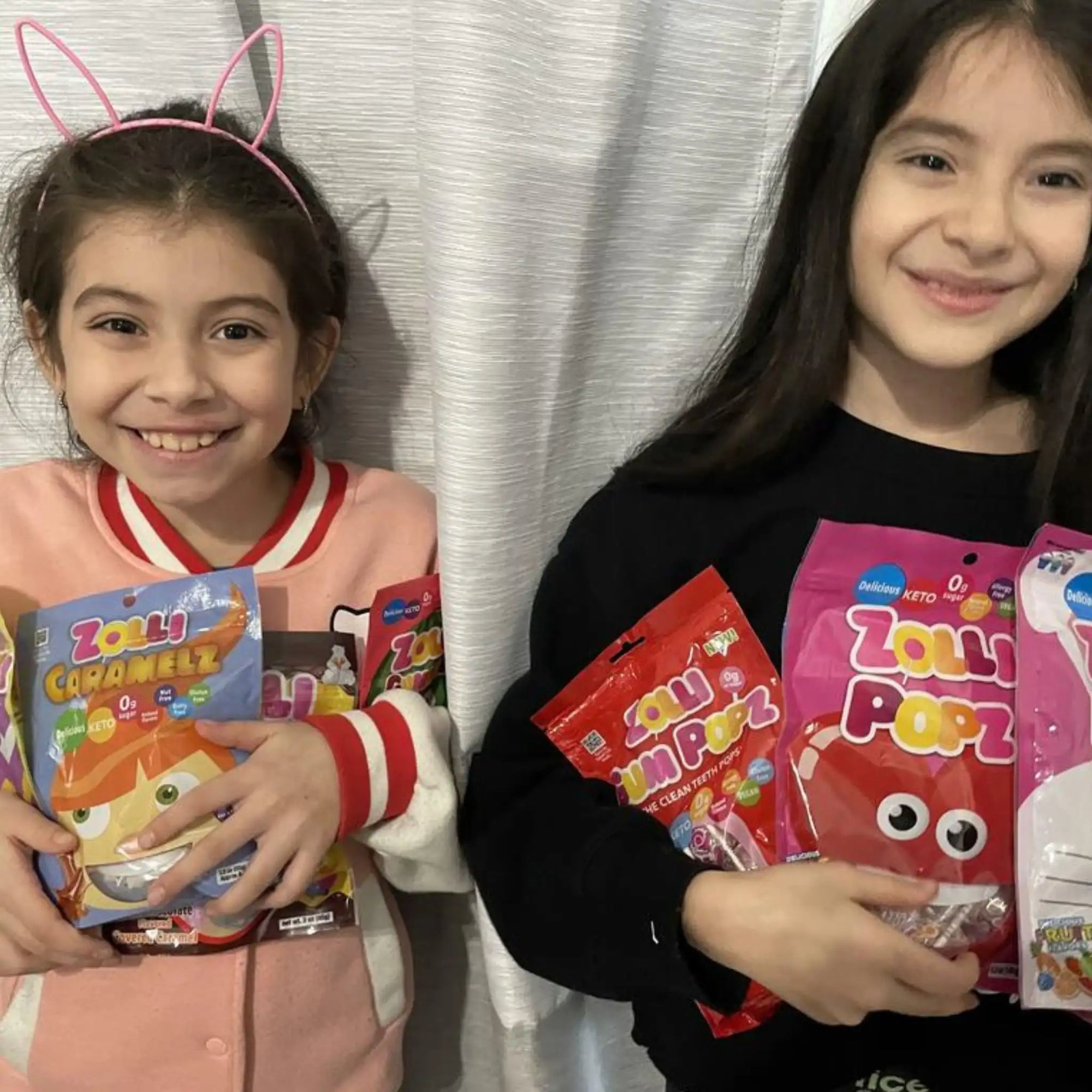Two girls with bags of zolli candy.