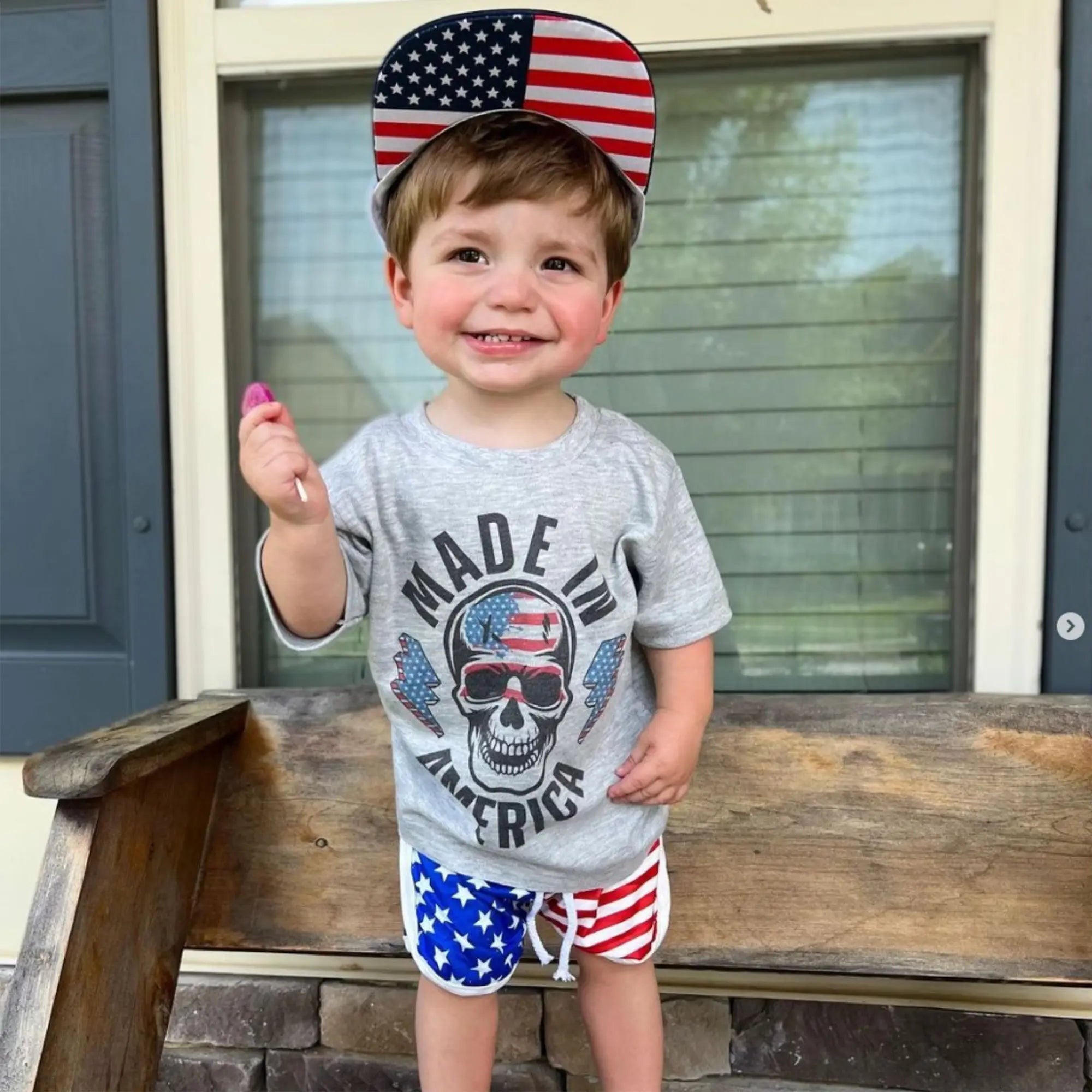 Child with a zollipop and usa hat.