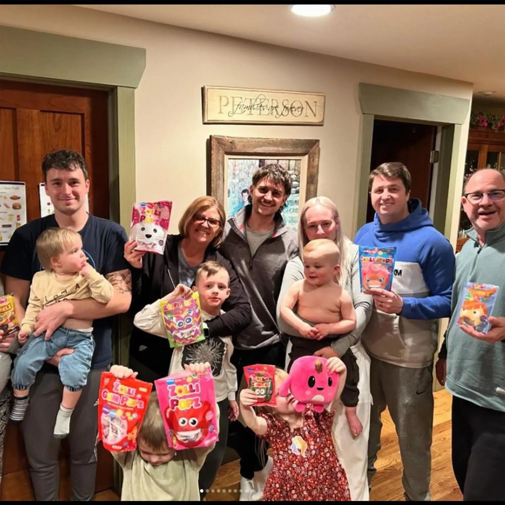 Happy family holding bags of zolli candy.