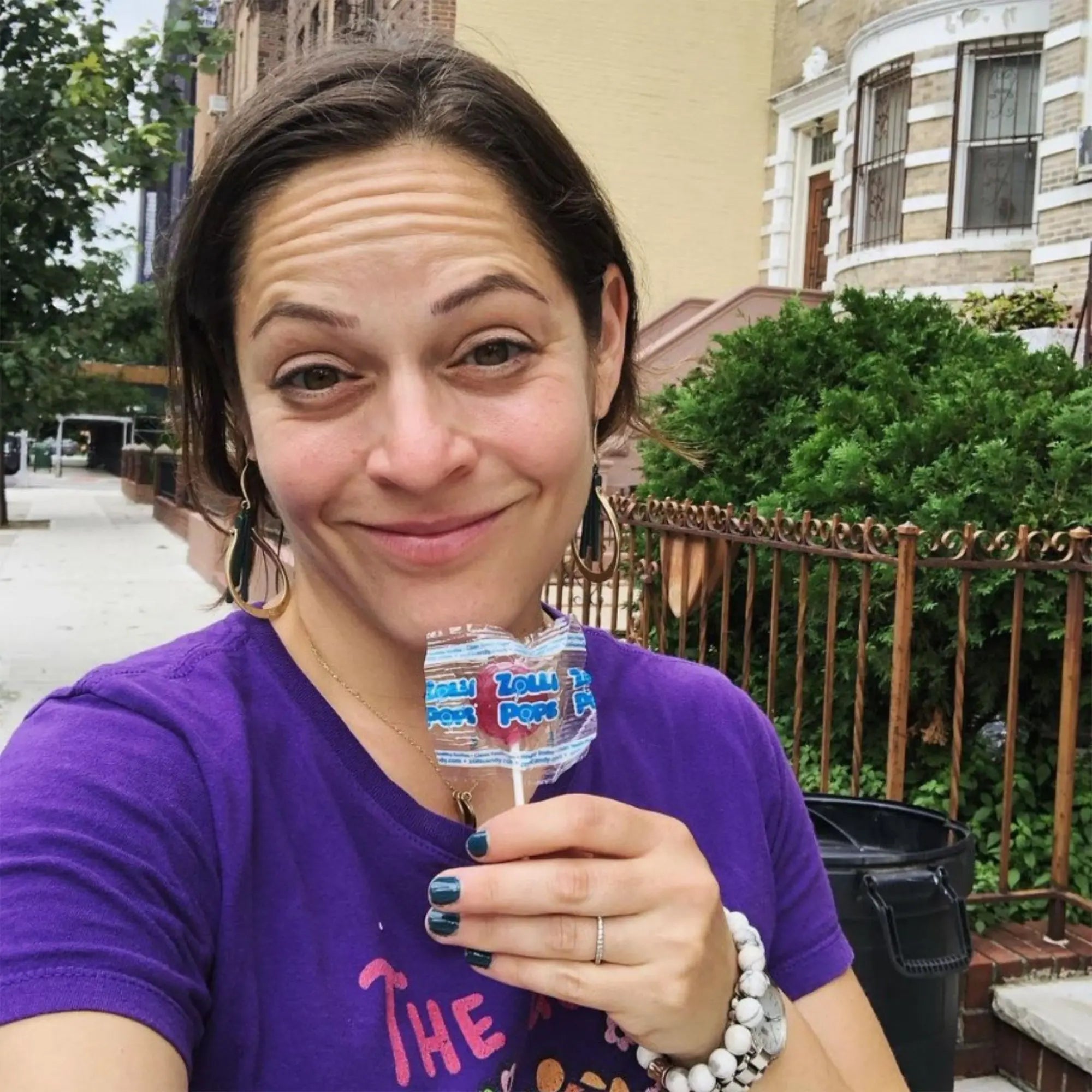 Woman with a grape zollipop.