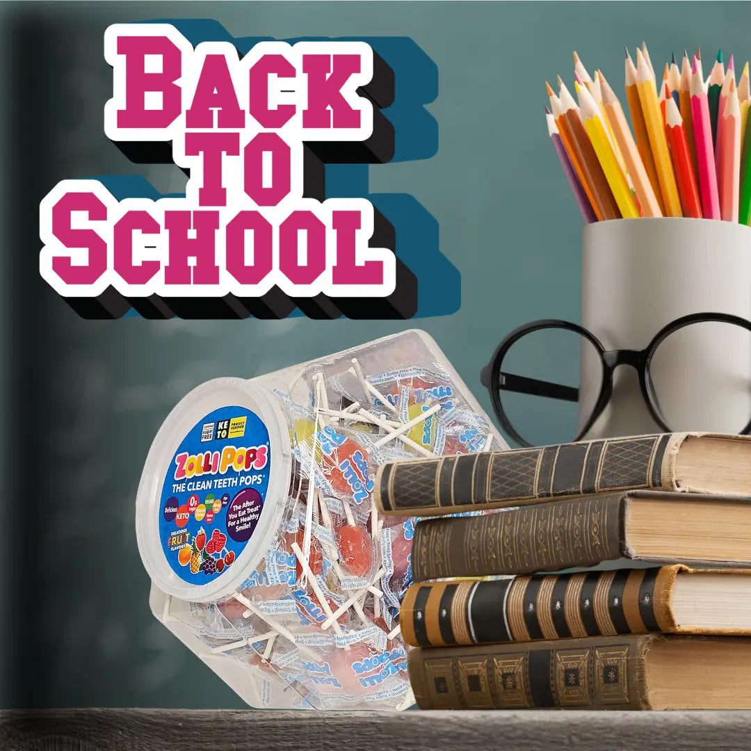 A clear plastic jar of Gummy Pops candy sits on a tabletop next to a stack of books, with a white cup of colored pencils and black-rimmed glasses behind it. Large pink and white 'BACK TO SCHOOL' text overlays the top left against a teal background.