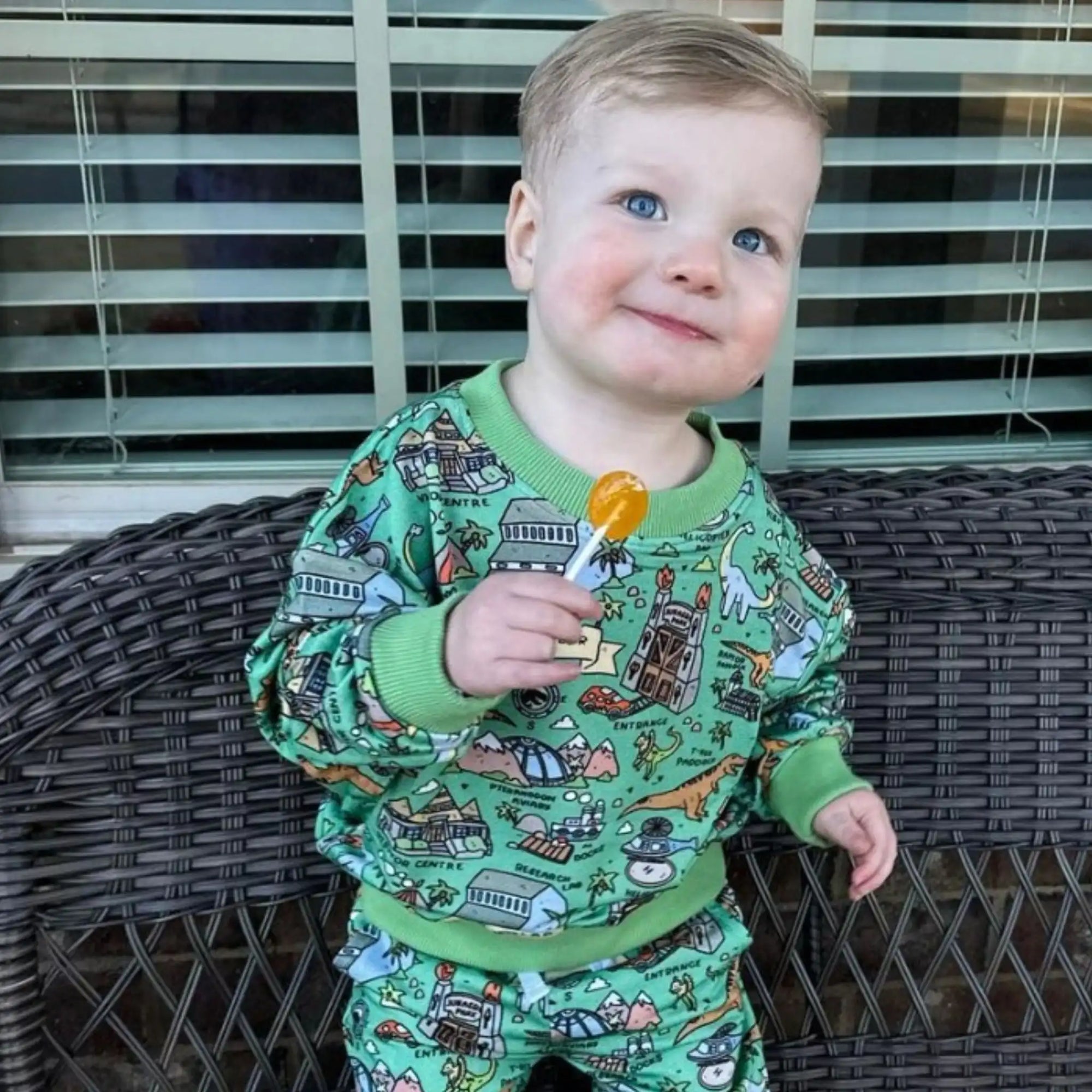 Boy smiling with a zollipop.