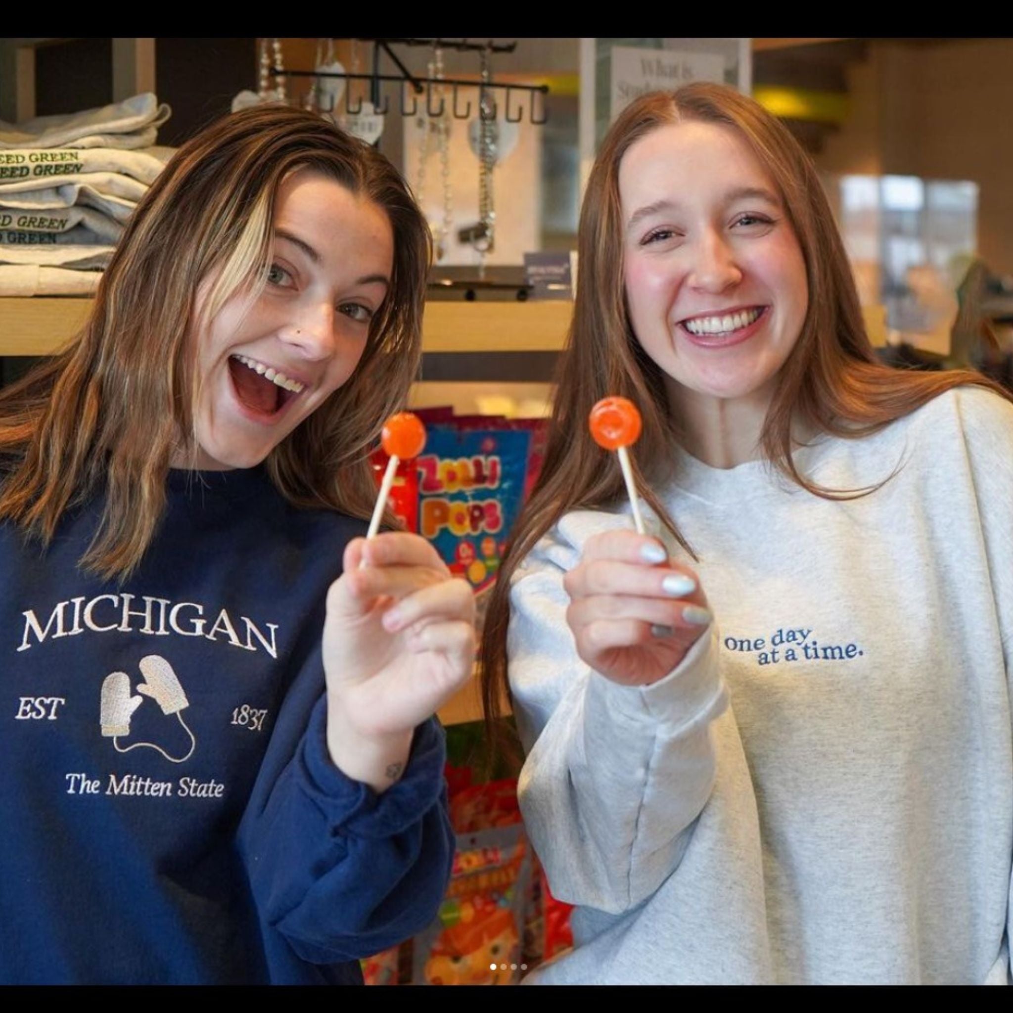 Two college girls with zollipops.