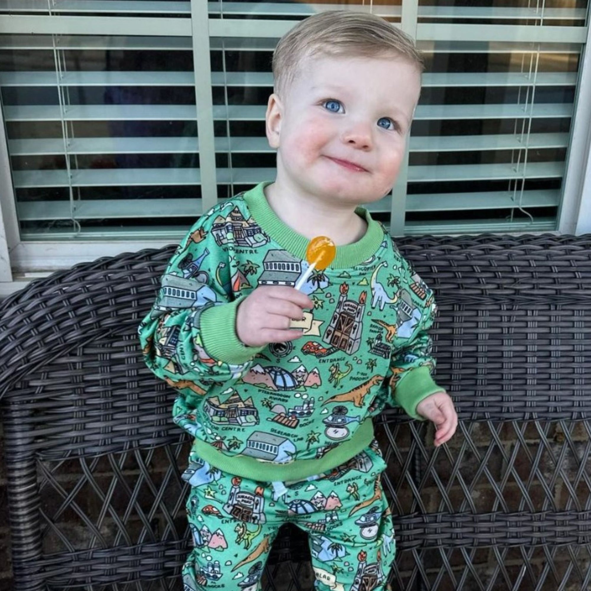 Boy smiling with a zollipop.