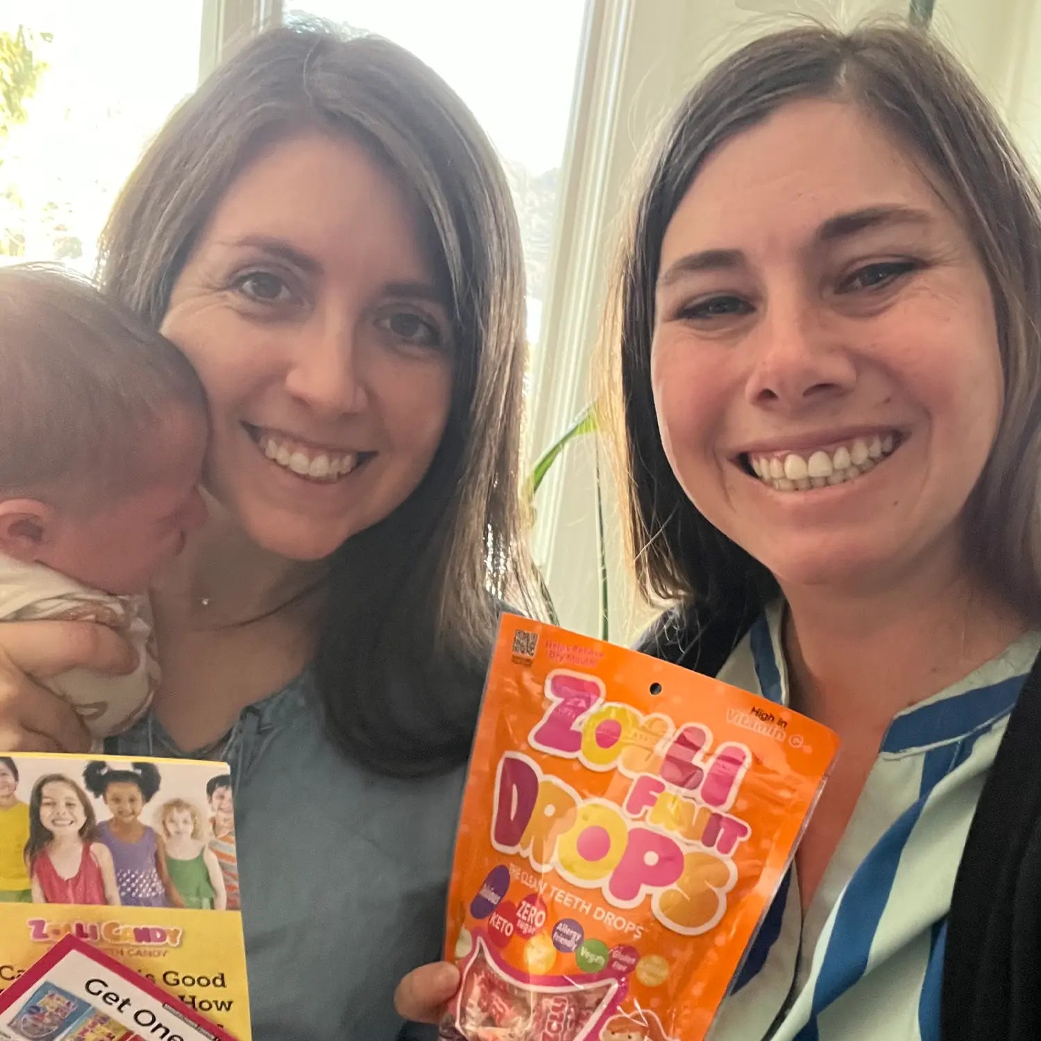 Women holding zolli fruit drops bag.