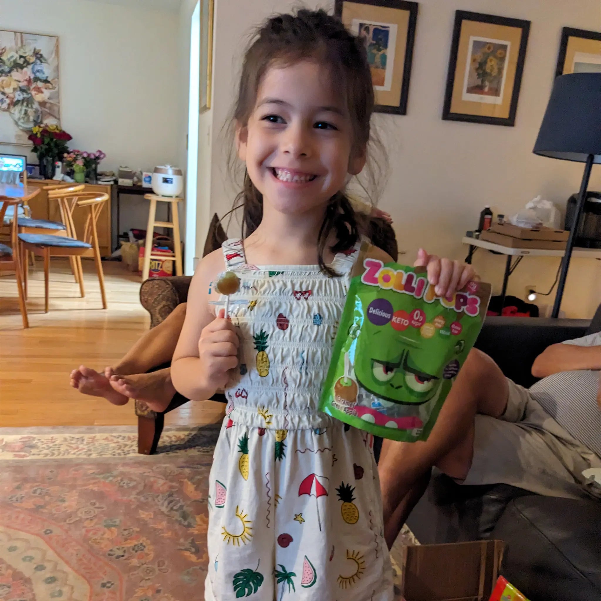 Zolli candy, girl holding candy bag and lollipop.